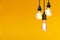 Vintage light bulb hanging over yellow background, Idea concept