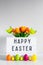 Vintage lightbox with happy Easter greetings, flowers, colorful eggs, decorative chicks and copy space over wall