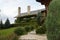 Vintage log wooden house covered by green ivy. Rural country house with chimney, cottage, covered with ivy, herbage. Eco