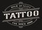 Vintage logo for the tattoo studio on a dark background