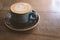 Vintage looking Coffee cup with perfect latte art on foam side view on tabletop