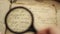 Vintage manuscript and magnifying glass.