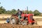 Vintage Massey Ferguson ploughing on stubble in crop field