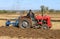 Vintage Massey Ferguson ploughing on stubble in crop field