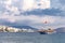 Vintage mast wooden sailing ship for sea tours in port of Saranda, Albania on the background of Saranda town. Cloudy day. Sea