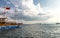 Vintage mast wooden sailing ship for sea tours in port of Saranda, Albania with red state albanian flag with black double-headed