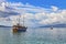 Vintage mast wooden sailing ship for sea tours in Saranda gulf, Albania with red state albanian flag with black double-headed