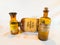Vintage Medicine Bottles: Lapisvand, Glandula Lupuli, and Aqua Bardanea F.D.A. on White Background