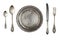 Vintage metal antique plate, spoon and fork isolated on a white background.