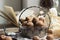 A vintage metal and glass vase with walnuts, in the background an antique clock, a marble figurine of a bear and an open book.