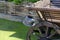 A vintage metal kettle hanging on an old wooden cart