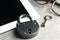 Vintage metal lock with key and tablet on table, closeup. Protection from cyber attack