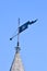 Vintage metal rooftop spire aka spile on the wooden building roof on blue sky in sunny day,, travel diversity,