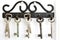 Vintage metallic hooks hanging old keys on white background