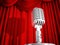 Vintage Microphone Against a Red Curtain