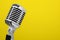 Vintage microphone isolated on yellow