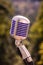 Vintage microphone, metallic retro style. Outdoor live show concept