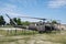 Vintage military helicopter displayed in an airbase during a sunny day