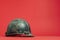 Vintage military helmet on red background