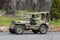 Vintage Military Jeep driving on country road