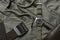 Vintage military watch with nato strap and tactical belt on army green background, Classic timepiece mechanical wristwatch