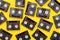 Vintage mini DV cassette tapes used for filming back in a day. Random pattern made of plastic video tapes on yellow background