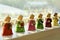 Vintage, Miniature and Colourful Angel Bells are Rear Life by Heavenly Sunshine on a Shelve during Christmas Season