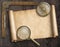 Vintage nautical compass and loupe on table with treasure map scroll