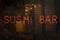 Vintage Neon Sushi Bar Sign in Wet Rainy Window