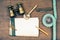 Vintage notebook, compass, binoculars, old pocket knife, pencil, magnifying glass on wooden desk background