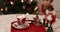 Vintage nutcrackers and cup of marshmallow cacao on red tray with Christmas lights