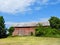 Vintage NYS FingerLakes red barn under blue sky