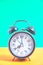 Vintage old alarm clock on a background of pastel retro colors