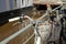 A vintage old bicycle leaned on a metal railing along a city stream in Freiburg in Germany called Baechle.