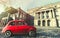 Vintage old classic italian red car. Osgoode Hall, historic building. Toronto, Canada