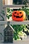 Vintage old-fashioned retro Halloween outdoor decorations. Garden Halloween decor with pumpkin, metal house