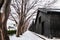 Vintage old Japanese black warehouse in winter snow and tree lin
