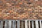 Vintage old red brick wall leaning weathered pallets