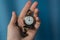 Vintage old watch on a chain. hand holding a watch on a chain.