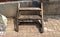 Vintage Old Wooden Plant Rack/ Shelf/ Ladder/ Stool Chair with Dirty Wall Background - Outdoor Garage/ Abandoned Junkyard/ Home Ga