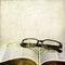 Vintage open book and classic eyeglasses