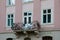 Vintage open wrought-iron balconies on a background of moldings window