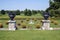 Vintage ornaments on pedestals in a topiary garden