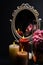 Vintage Oval Desk Mirror with white frame, potpourri, and candles reflecting in mirror on black background