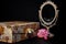 Vintage Oval Desk Mirror with white frame, Potpourri pieces and a keepsake box on black background