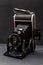 Vintage photo camera with aesthetic metallic elements, beautiful old fashioned font and leather harmonic.