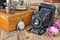 Vintage photo camera, pocket watches and dried roses