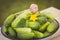 Vintage photo, Cucumbers and garlic in metal bowl in garden on sunny day