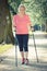 Vintage photo, Elderly senior woman practicing nordic walking, sporty lifestyles in old age