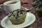 Vintage photo, Fresh muffins with spinach, desiccated coconut, chocolate glaze and cup of coffee, delicious healthy dessert